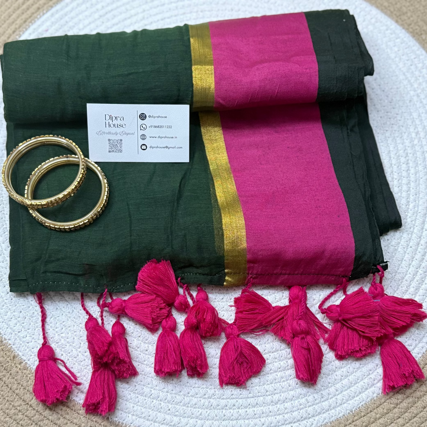 Green mulmul saree with contrast pink border along with gold zari