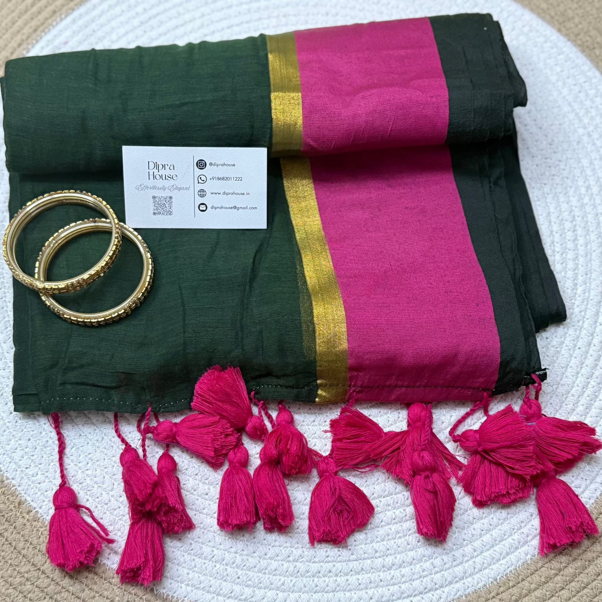 Green mulmul saree with contrast pink border along with gold zari